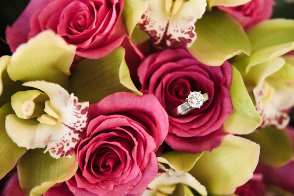 close up photo of wedding ring in pink rose bouquet - photo by Hawaii based wedding photographer Derek Wong